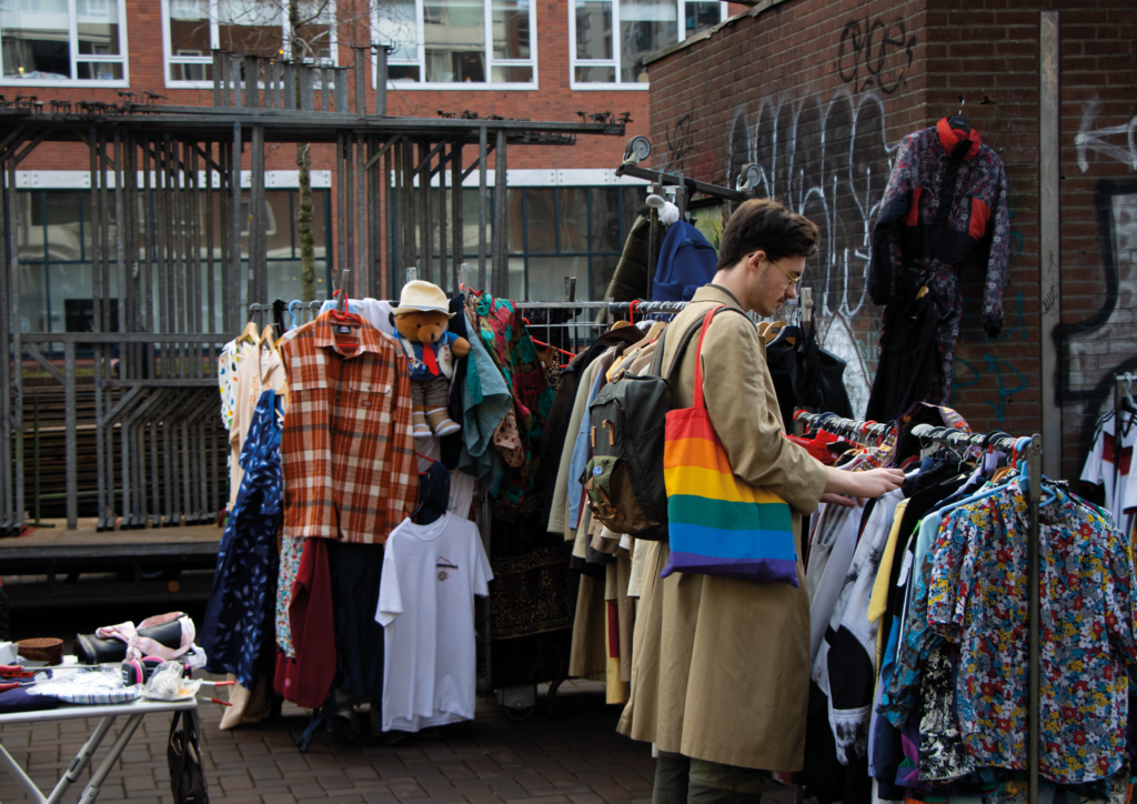 Man searching for clothes in a marketplace in Amsterdam